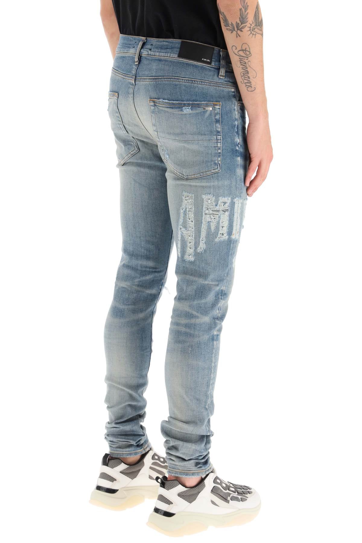 Amiri 'distressed logo' jeans