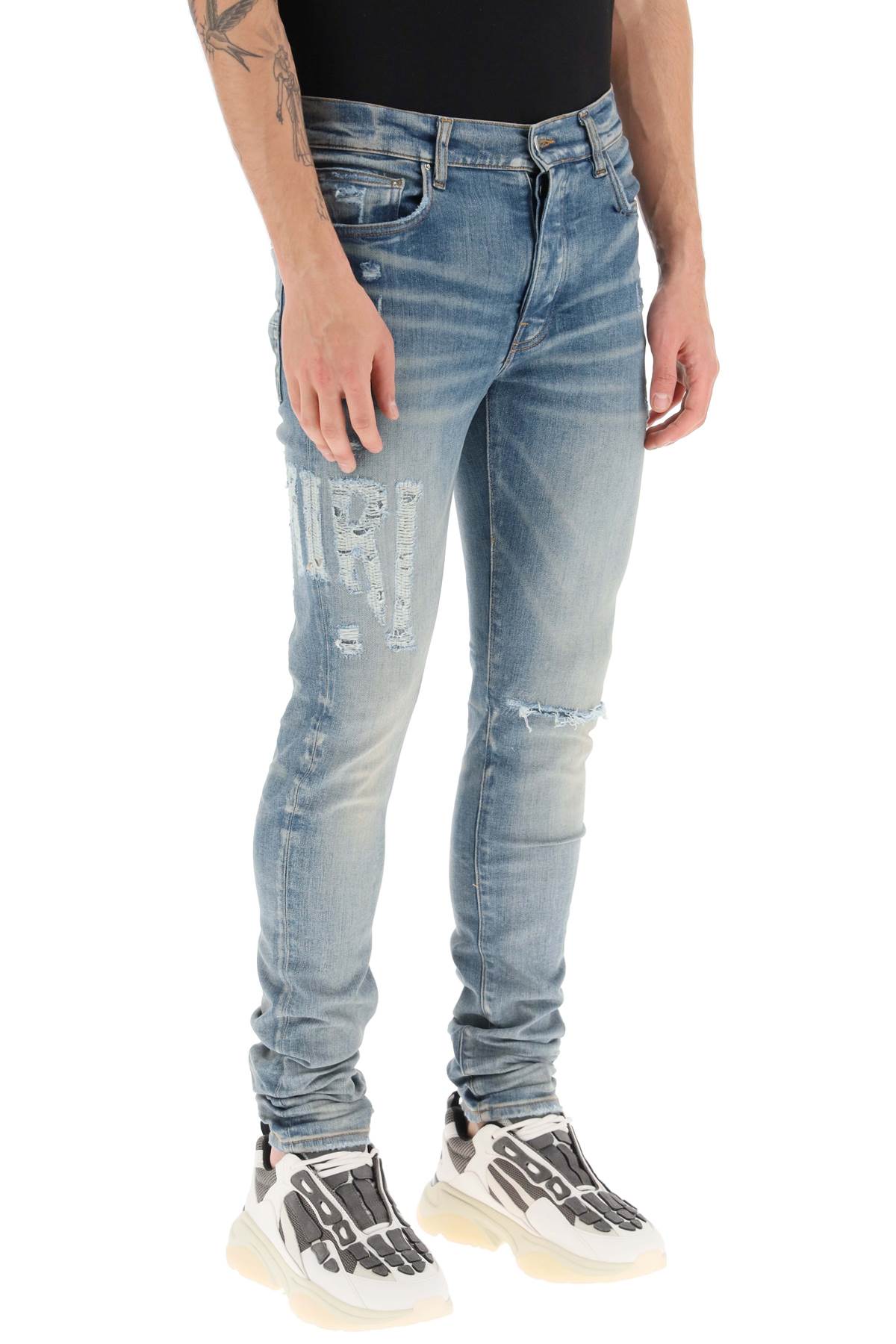 Amiri 'distressed logo' jeans