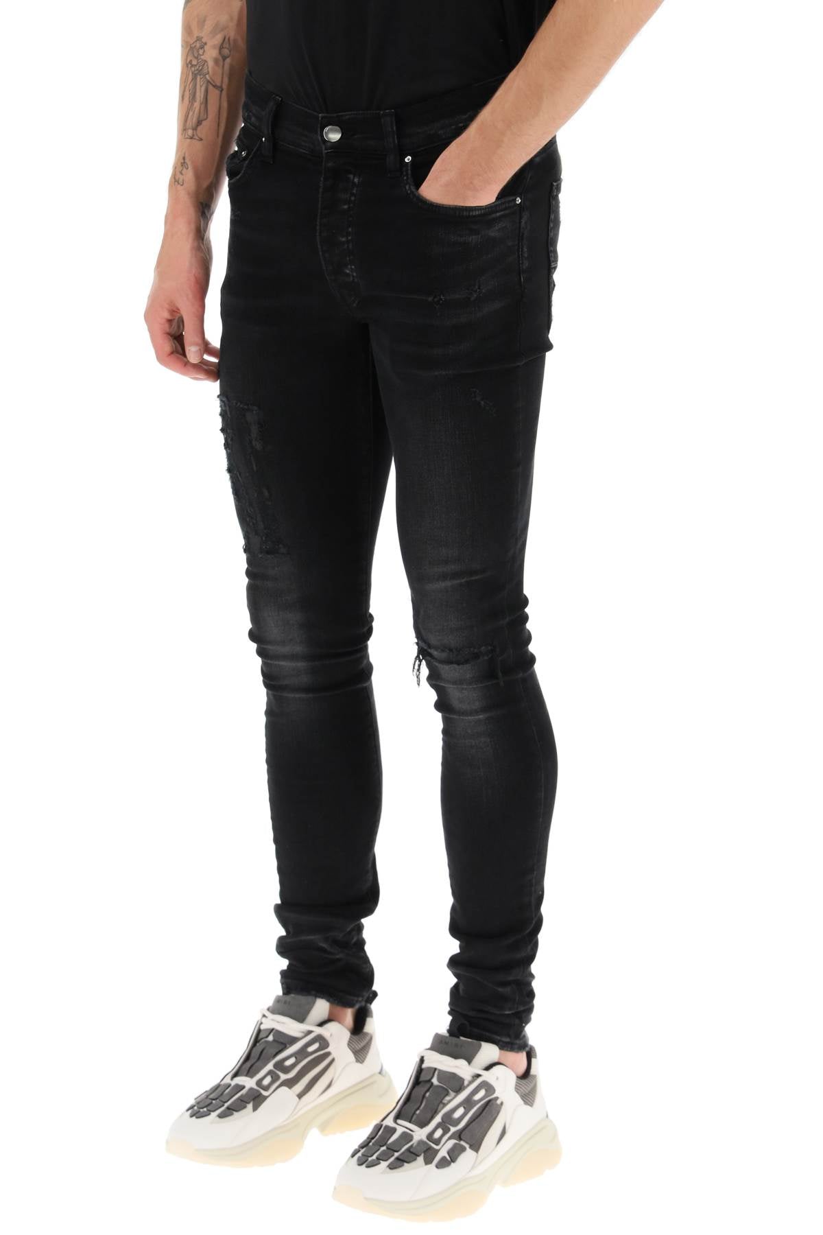 Amiri 'distressed logo' jeans